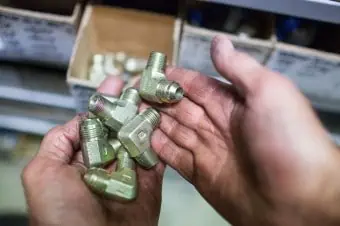 Greasy hands holding fittings
